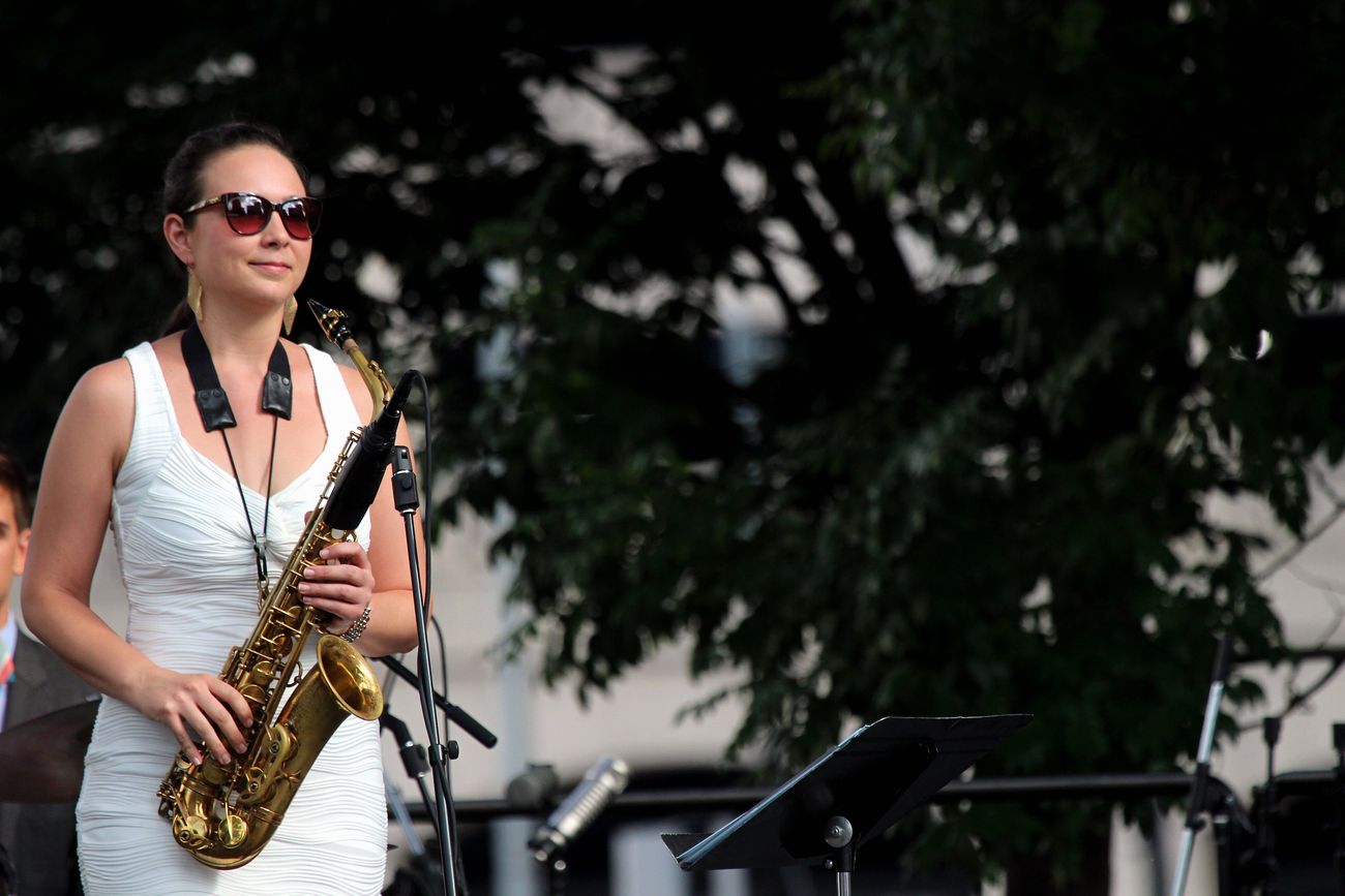 A saxophonist performing outdoors at the Detroit Jazz Festival